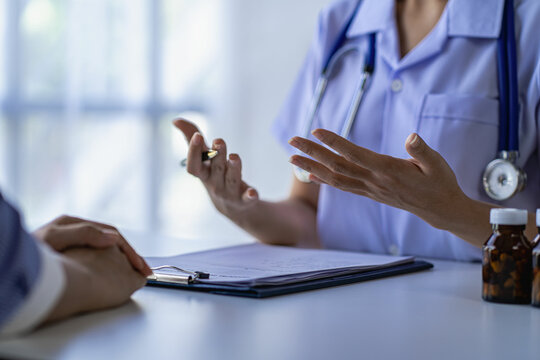 Smiling female doctor talking to woman in hospital Concept of counseling and giving advice on medicines to patients