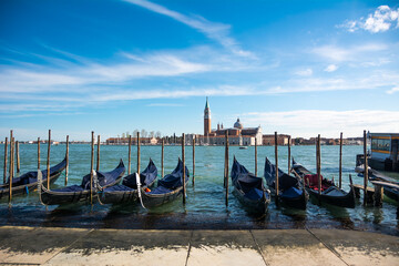 Fototapeta na wymiar View of the Grand Canal and gondolas and San Giorgio Maggiore Church at Venice, Veneto, Italy.