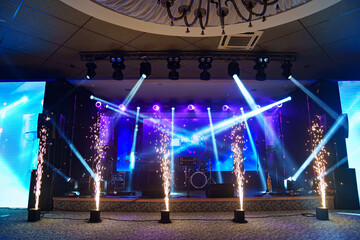 preparation of the stage in a dark banquet hall. 