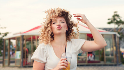 Girl with drink outdoors
