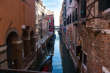 Narrow canal and ancient buildings at Venice, Veneto, Italy.