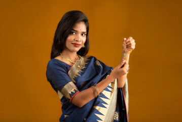 Beautiful Indian girl showing Rakhis on the occasion of Raksha Bandhan.