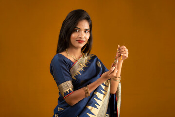 Beautiful Indian girl showing Rakhis on the occasion of Raksha Bandhan.