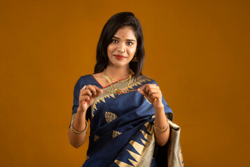 Beautiful Indian girl showing Rakhis on the occasion of Raksha Bandhan.