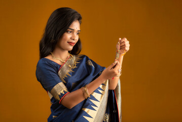Beautiful Indian girl showing Rakhis on the occasion of Raksha Bandhan.