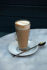 Close-up of latte coffee in a transparent cup with 