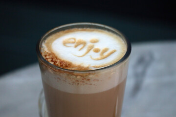 Close-up of latte coffee in a transparent cup with 