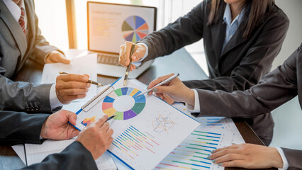 Group professional business people person working together to analyze in office, work together to discuss company financial statistics report, brainstorm ideas, and graph datum documents on the table.