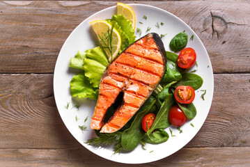 Grilled salmon steak with vegetable salad