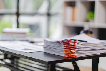 Document. A pile of documents with paper clip folders placed on the business desk in the business...
