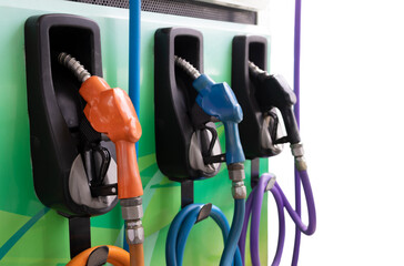 Colorful Petrol pump filling nozzles on Gas station background