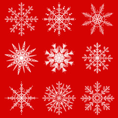 Naklejka na ściany i meble White snowflakes on the red background. Seamless pattern.