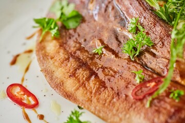 Beef tongue with sauce and herbs. A dish from the chef for serving in a restaurant.