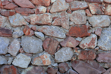 Stone wall texture. Front view colorful stone wall texture background