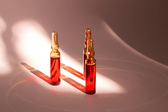 injections of B vitamins. Ampoules with red liquid. Beauty and health concept