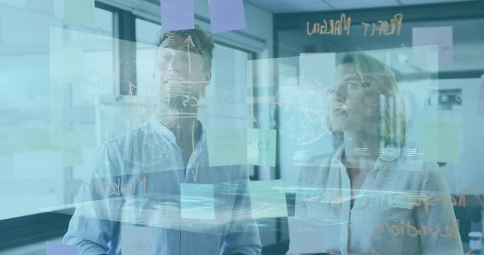 Animation of interface screen over caucasian colleagues discussing over adhesive notes on glass wall
