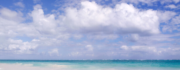 Travel background with Caribbean sea and clouds sky.