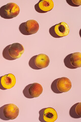 Pieces of peach and peaches on a pink background
