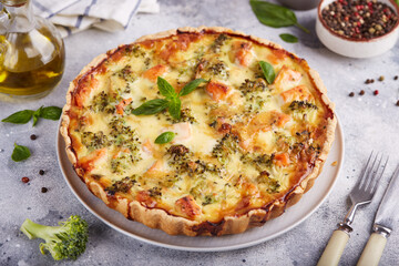 Quiche open tart pie with salmon fish and broccoli. Savory taste.