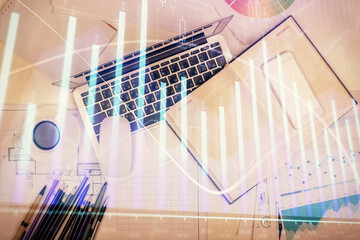 Multi exposure of forex chart drawing over table background with computer. Concept of financial research and analysis. Top view.