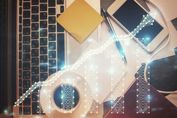 Double exposure of financial chart drawing over table background with computer. Concept of research and analysis. Top view.