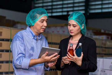 Fototapeta premium Customer visits a warehouse or factory in order to drink purchase decision. Owner explaining Products to customer. Checking goods quality for import and export.