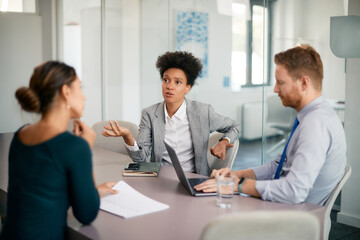 Multiracial business team discussing during meeting at corporate office.