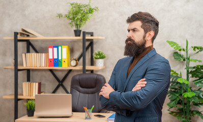 serious unshaven boss wear suit in the office with copy space, charisma