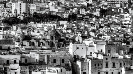 Overview of Ostuni (BR), the white city perched on the hill, with the typical white houses. Aerial photo with the drone of June 2022 photo taken at dawn.