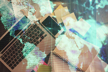 Business theme hologram drawings over computer on the desktop background. Top view. Multi exposure. Concept of international connections.