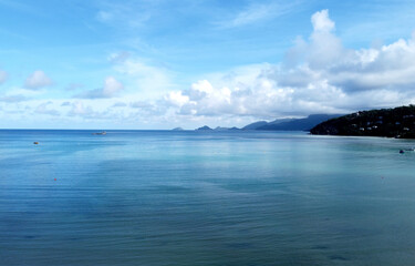 Beautiful panoramic landscape with clear blue ocean water and mountains on coast on Seychelles islands