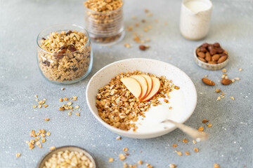 Homemade granola with milk, apples and nuts. Delicious and healthy breakfast.