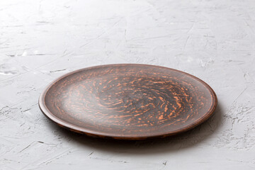 Perspective view of empty plate on cement background. Empty space for your design