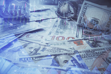 Multi exposure of forex chart drawing over us dollars bill background. Concept of financial success markets.