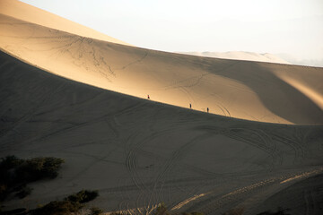 People clibing the dunes in Peruvian desert,Huacachina ,Ica,Peru