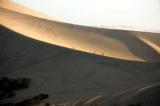 People clibing the dunes in Peruvian desert,Huacachina ,Ica,Peru