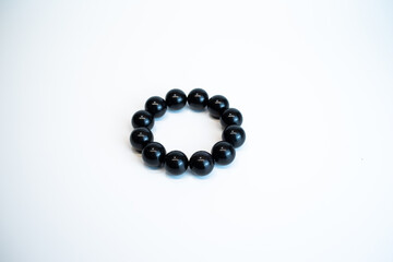 Close up of Obsidian Bracelet,Natural stone jewelry bracelets. Lucky bracelet. Handmade bead bracelet, bracelet made of stone round.