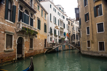 Narrow canal and bridge and ancient buildings at Venice, Veneto, Italy.