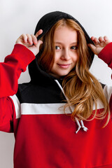 Portrait of fashion kid in soft cosy hoodie on white background