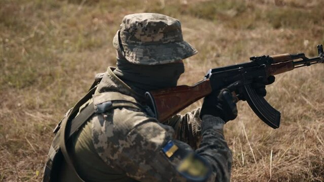 Military Special Forces Unit of soldiers with weapons and ammunition are on the battlefield, attacking the enemy