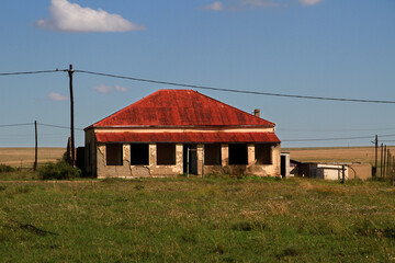 Photo of abandoned old houses and buildings in South Africa, red stone, mud and stone walls