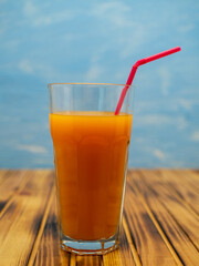 Full glass of orange juice close-up. Fresh orange juice on wooden table