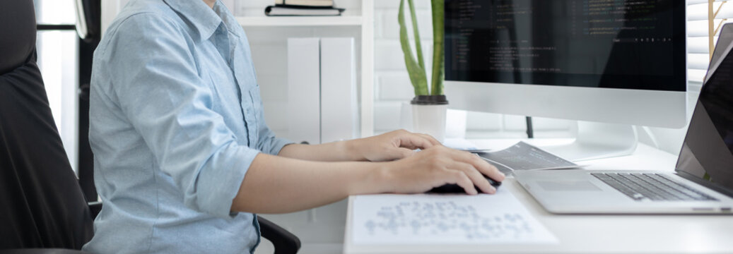 Professional development programmers are sit on a desk with work equipment such as: computer-laptop-tablet. for working in programming or writing code on  website,  HTML, javascript, Software.