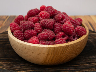 Raspberries in wooden bowl. Raspberry with copy space for text