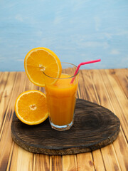 Glass of orange juice and oranges isolated on white background