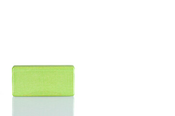 Wooden cube of green color on a white background