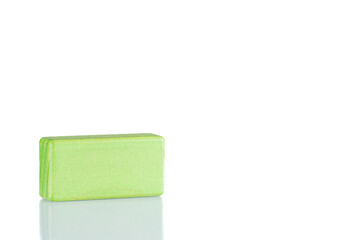 Wooden cube of green color on a white background