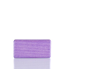 Wooden cube of purple color on a white background