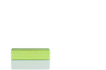 Wooden cube of green color on a white background
