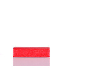 Wooden cube of red color on a white background